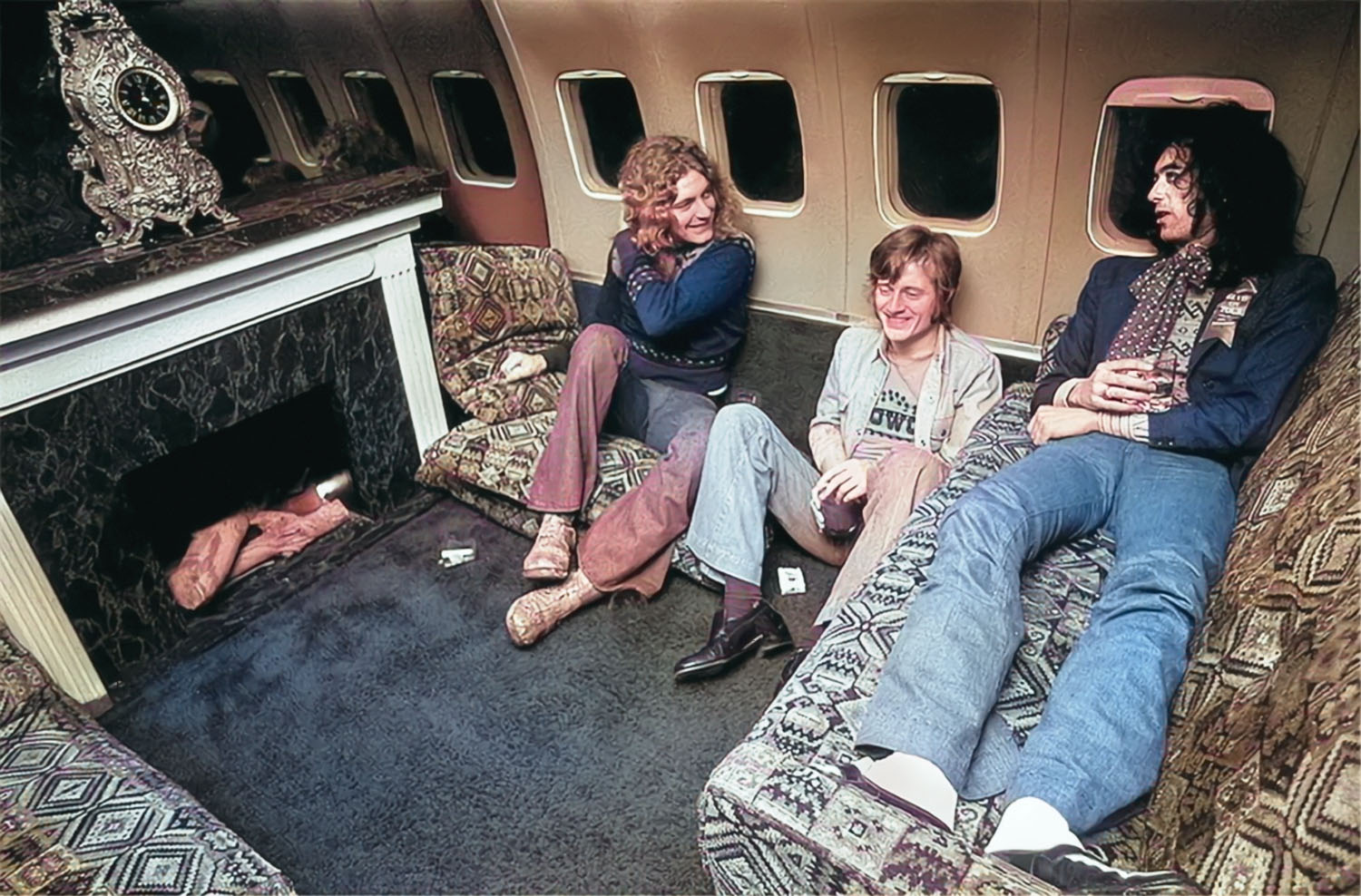 starship-fake-fireplace Led Zeppelin members Robert Plant, John Paul Jones and Jimmy Page chat in front of a fake fireplace on The Starship Boeing 720