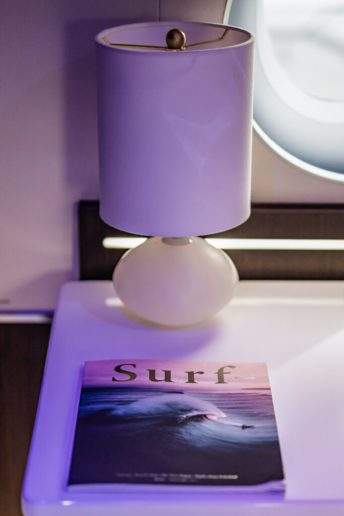 a magazine placed on a side table in a private jet